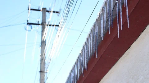 Icicles near the swinging electrical cables Vídeo Stock 70751368