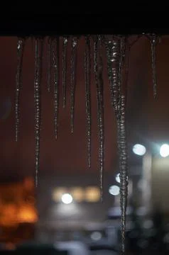 Icicles with night lights Stock Photos