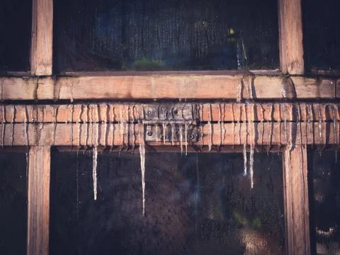 Icicles on Old Wooden Window Front View Stock Photos