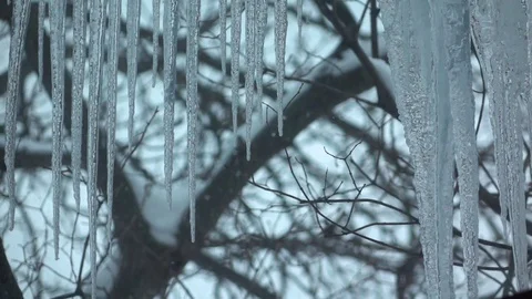 Icicles outside the window and snow falling. Slow-mo Stock-Footage 83729681