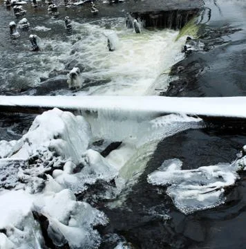 Icicles on the river rapids. Winter landscape. Stock Photos