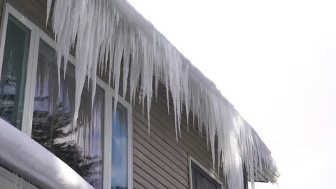 Icicles on a snowy gutter in the winter Video stock 93427142