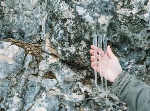 Icicles on stone wall Stock Photos