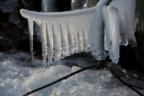Icicles in stream Stock Photos