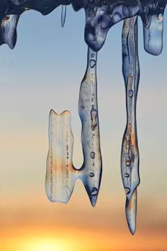 Icicles transparent on the background of the sunset Stock Photos
