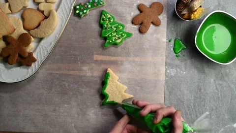 Icing Christmas tree shaped sugar cookie, top view. Christmas preparations. Stock Footage 145229436