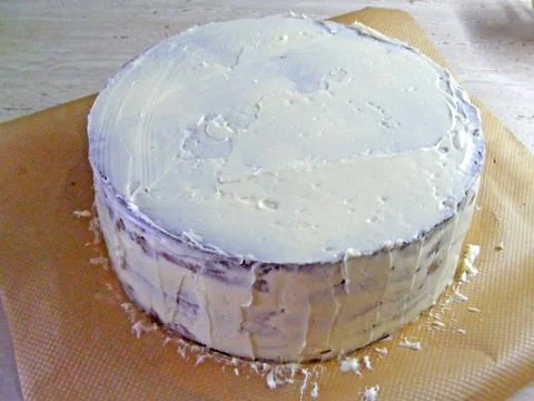 Icing a layer cake Stock Photos