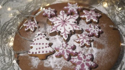 Icing sugar falling on a gingerbread on a background of lights Stock Footage 70791046