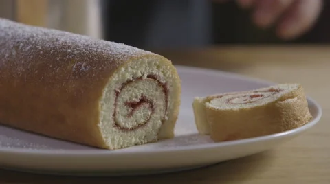 Icing sugar on a swiss roll Stock Footage 64022547