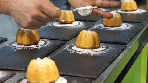 Icing sugar on top of mini cakes Stock Footage 72550473