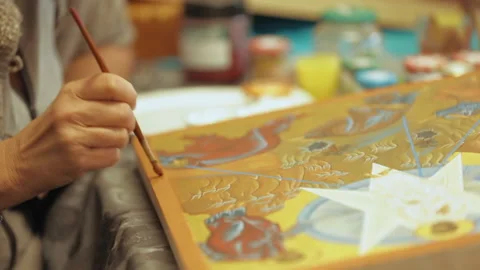 An icon painter is finishing work on a new icon. Stock Footage 231482523