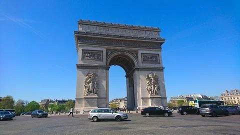 The iconic Arc de Triomphe standing majestically against a clear blue sky with Stock Photos