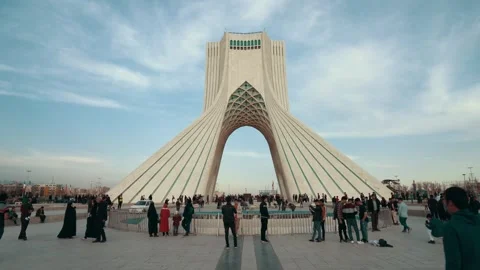 Iconic Azadi Tower landmark in Tehran, Iran, with people gathered below Stock Footage 335946841