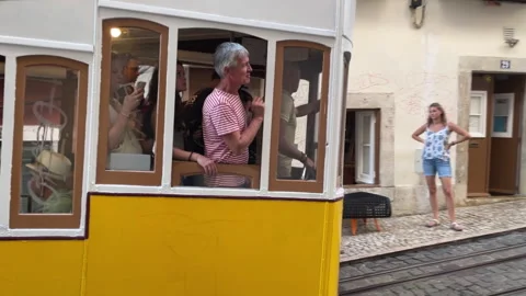Iconic Bica Funicular Cable Car with Passengers on Historic Street in Lisbon Stock Footage 340403535