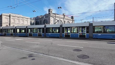 Iconic blue tram driving on busy street in Zurich old town with passengers,.. Stock Footage 343593422