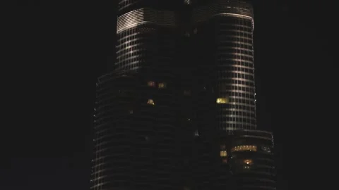 Iconic Burj Khalifa skyscraper lit up against dark night sky in UAE Stock Footage 340259840