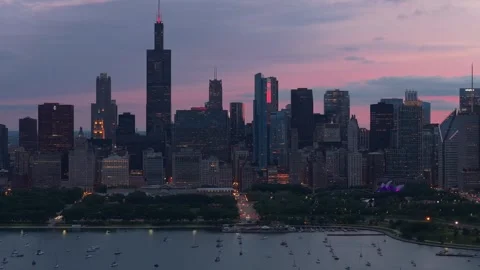 Iconic Chicago skyline glowing at twilight with Willis Tower and city lights ref Stock Footage 337896000
