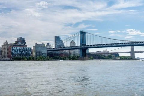 Iconic cityscape featuring a bridge over a river, under a partly cloudy blu.. Stock Photos