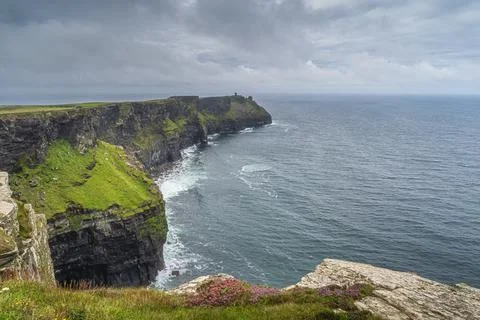 Iconic Cliffs of Moher with Moher Tower on far distance, Ireland Stock Photos