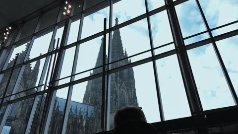 Iconic Cologne Cathedral Seen Through Modern Glass Window with Reflection Stock Footage 325124852