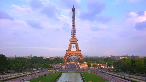 Iconic eiffel tower in paris with cloudy sky at sunset, people walking in p.. Stock Footage 337749439