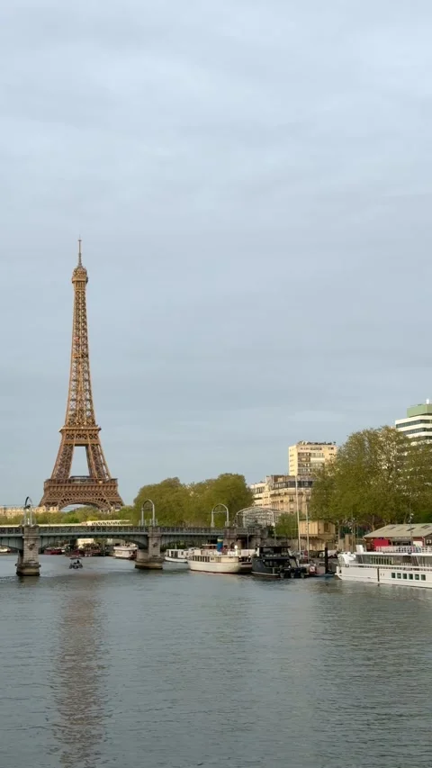 Iconic Eiffel Tower standing over the Seine river in Paris, France Stock Footage 337024472