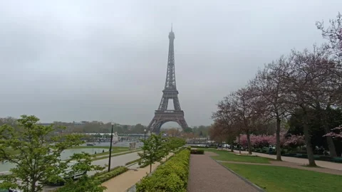 Iconic Eiffel Tower standing tall against a foggy sky Stock Footage 342393618
