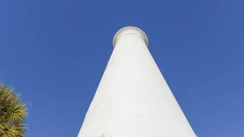Iconic lighthouse structure rising against a clear blue sky, showcasing Stock Photos