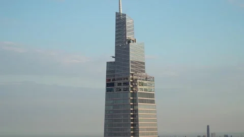 Iconic modern skyscraper standing tall with blue sky in the background Stock Footage 290849992