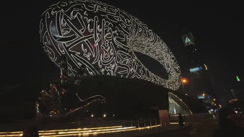 Iconic Museum of the Future with Arabic calligraphy lit up at night Stock Footage 340195290