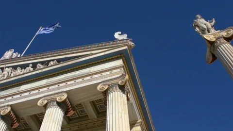 The iconic neoclassic Academy of Athens facade with Greek flag waving Stock Footage 101009194