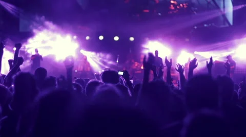 Iconic night rock concert front row crowd cheering hands in air slomo 100p Stock Footage