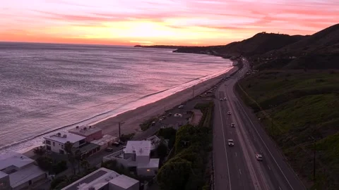 Iconic Pacific Ocean View at Pretty Pink Sunset Over Beach Shore. PCH Highway 1 Stock Footage 334942098