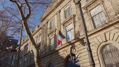 Iconic Paris building facade with waving flag of France and Europe, Stock Footage 235926482