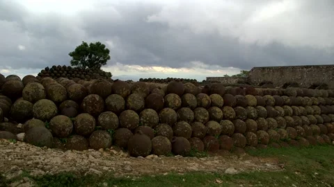 Iconic pile of hundreds of rusted, mossy cannonballs at Citadelle Laferrière Stock Footage 332522145