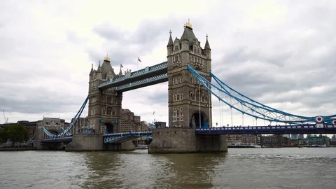 Iconic red double decker bus passing over iconic Tower Bridge in London, UK Stock Footage 94723075