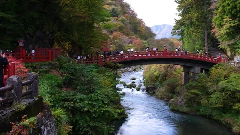The iconic red Shinkyo Bridge over the Daiya River in Nikko, Japan Stock Footage 335580550