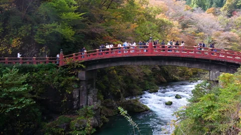 The iconic red Shinkyo Bridge over the Daiya River in Nikko, Japan Stock Footage 335581397