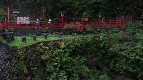 The iconic red Shinkyo Bridge over the Daiya River in Nikko, Japan Stock Footage 335581567