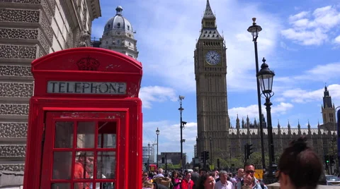 An iconic red telephone booth in front of Big Ben and Houses Of Parliament in Stock Footage 55775684