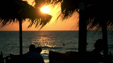 Iconic romantic idyllic sunset at beach,slow motion.Silhouetted couple in love. Stock Footage 54143536