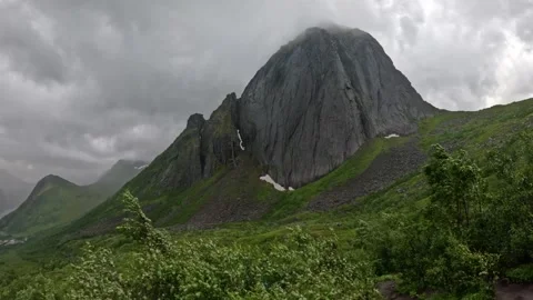 Iconic Segla mountain peak in mist with windy foliage foreground in Senja Norway Stock-Footage 342059370