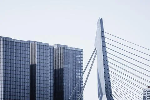 Iconic skyscraper and bridge against sky in Rotterdam Stock Photos