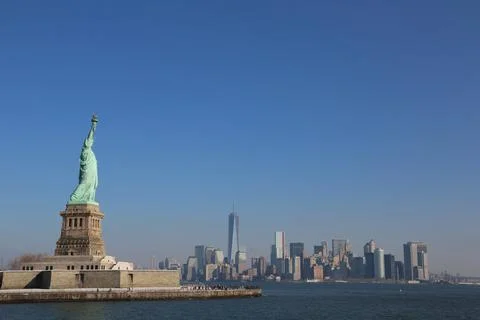 Iconic Statue of Liberty in front of New york city Stock Photos