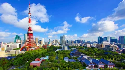 Iconic Tokyo Tower Against Blue Sky with City Skyline Stock Footage 331337987