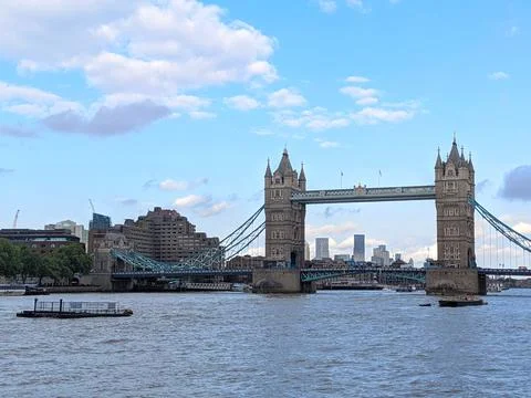 Iconic Tower Bridge spans the River Thames in London under a dynamic cloudy sky Stock Photos