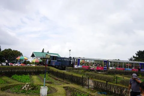 Iconic toy train passing through the scenic Batasia Loop in Darjeeling Stock Photos