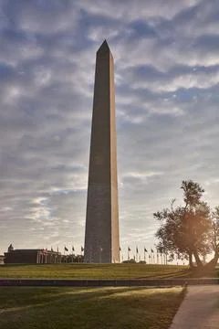 Iconic Washington Monument Under a Dramatic Sky at Sunset with lens flares Stock Photos