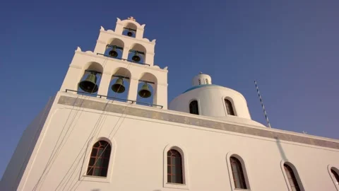 Iconic whitewashed chapel in Santorini with a striking bell tower and blue dome Stock Footage 314561653