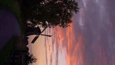 Iconic Windmill Silhouette Against a Dramatic Sunset Sky in the Netherlands Stock Footage 339545438